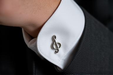 Sterling silver music note cufflinks on a tuxedo cuff